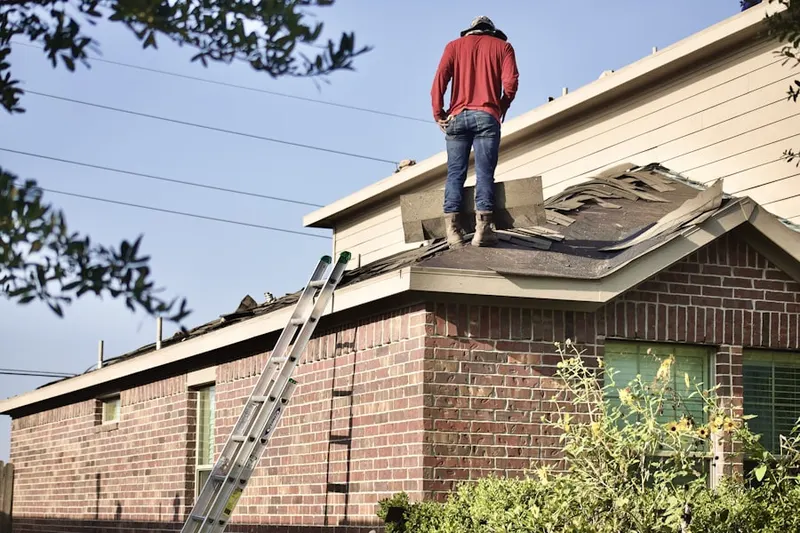 Professional roofer working on a residential roof in Garden Hills